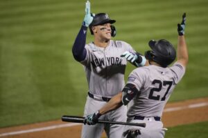 New York Yankees’ Aaron Judge, left, celebrates with Giancarlo Stanton (27) after hitting a solo home run during the seventh inning of a baseball game against the Oakland Athletics, Saturday, Sept. 21, 2024, in Oakland, Calif.