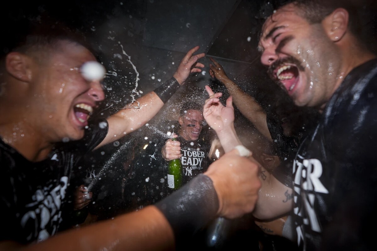 New York Yankees’ Aaron Judge, center, celebrates clinching a playoff spot with teammates, including catcher Austin Wells, right, after a 2-1 win over the Seattle Mariners in a baseball game Wednesday, Sept. 18, 2024, in Seattle.