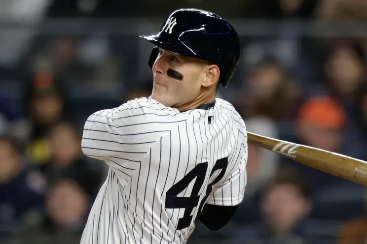 Anthony Rizzo, New York Yankees first baseman, preparing for an at-bat during a game, as his recent struggles at the plate with a .207 batting average since returning from the IL have raised questions about his role in the lineup. Fans are increasingly vocal about potential changes to the Yankees' starting roster.