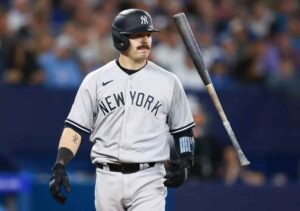 Austin Wells, Yankees rookie catcher, made a crucial throw to third base in the 10th inning, securing the Yankees' 2-1 win over the Mariners and clinching their postseason berth