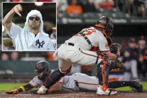 San Francisco Giants’ Heliot Ramos slides into home base to score in front of Baltimore Orioles catcher James McCann during the fourth inning of a baseball game, Wednesday, Sept. 18, 2024, in Baltimore.