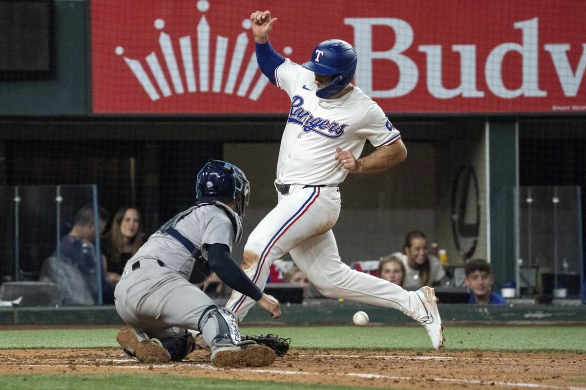 Texas Rangers’ Wyatt Langford scores past New York Yankees catcher Jose Trevino on a single by Nathaniel Lowe during the fourth inning of a baseball game Wednesday, Sept. 4, 2024, in Arlington, Texas.