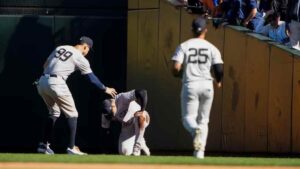 Yankees starter Juan Soto, center, is checked on by centerfielder Aaron Judge and second baseman Gleyber Torres after colliding with the wall after making a catch on a foul ball from the Mariners' Jorge Polanco during the seventh inning of a game Thursday in Seattle.