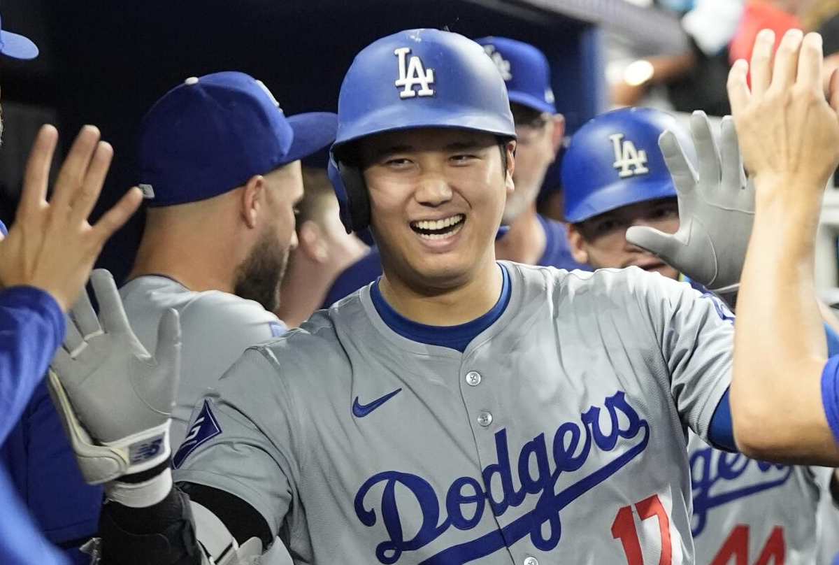 Dodgers phenomenon Shohei Ohtani rounding the bases after hitting his 54th home run of 2024, showcasing his incredible two-way talent despite being sidelined from pitching, as he led the Dodgers to an NL West title.