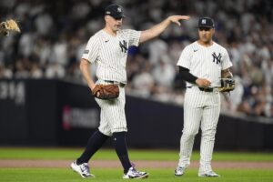 New York Yankees pitcher Carlos Rodón motions to the dugout after knocking down a line drive ball during the third inning of Game 2 of the American League baseball playoff series against the Kansas City Royals, Monday, Oct. 7, 2024, in New York. 