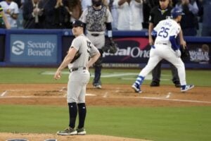 New York Yankees starting pitcher Carlos Rodón (55) looks to the outfield after giving up a home run to Los Angeles Dodgers’ Tommy Edman (25) during the second inning in Game 2 of the baseball World Series, Saturday, Oct. 26, 2024, in Los Angeles.