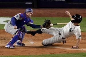 New York Yankees’ Giancarlo Stanton is tagged out at home by Los Angeles Dodgers catcher Will Smith during the fourth inning in Game 3 of the baseball World Series, Monday, Oct. 28, 2024, in New York.