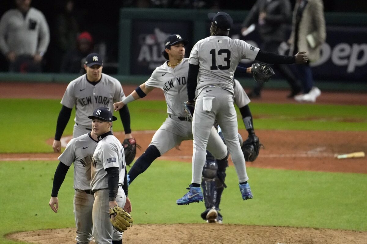 New York Yankees’ Jazz Chisholm Jr. (13) and Oswaldo Cabrera celebrate after Game 4 of the baseball AL Championship Series against the Cleveland Guardians Friday, Oct. 18, 2024, in Cleveland. The Yankees won 8-6 to take a 3-1 lead in the best-of-seven series.