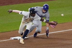 Los Angeles Dodgers’ Kiké Hernández, right, is safe at third as New York Yankees third baseman Jazz Chisholm Jr. reaches for a throw from shortstop Anthony Volpe during the fifth inning in Game 5 of the baseball World Series, Wednesday, Oct. 30, 2024, in New York. Volpe was charged with a throwing error.