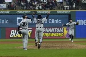 New York Yankees’ Luke Weaver (30), Jose Trevino (39) and Anthony Volpe celebrate after Game 5 of the baseball AL Championship Series against the Cleveland Guardians Saturday, Oct. 19, 2024, in Cleveland. The Yankees won 5-2 to advance to the World Series.