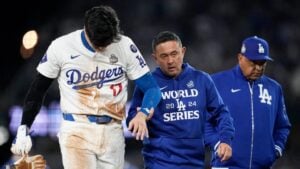 Shohei Ohtani is helped off the field after getting hurt in Game 2 of the World Series against the New York Yankees, Oct. 26, 2024.