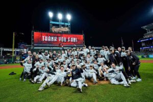 The New York Yankees roster and manager Aaron Boone celebrated their AL Championship trophy after qualifying for the World Series on October 19, 2024.