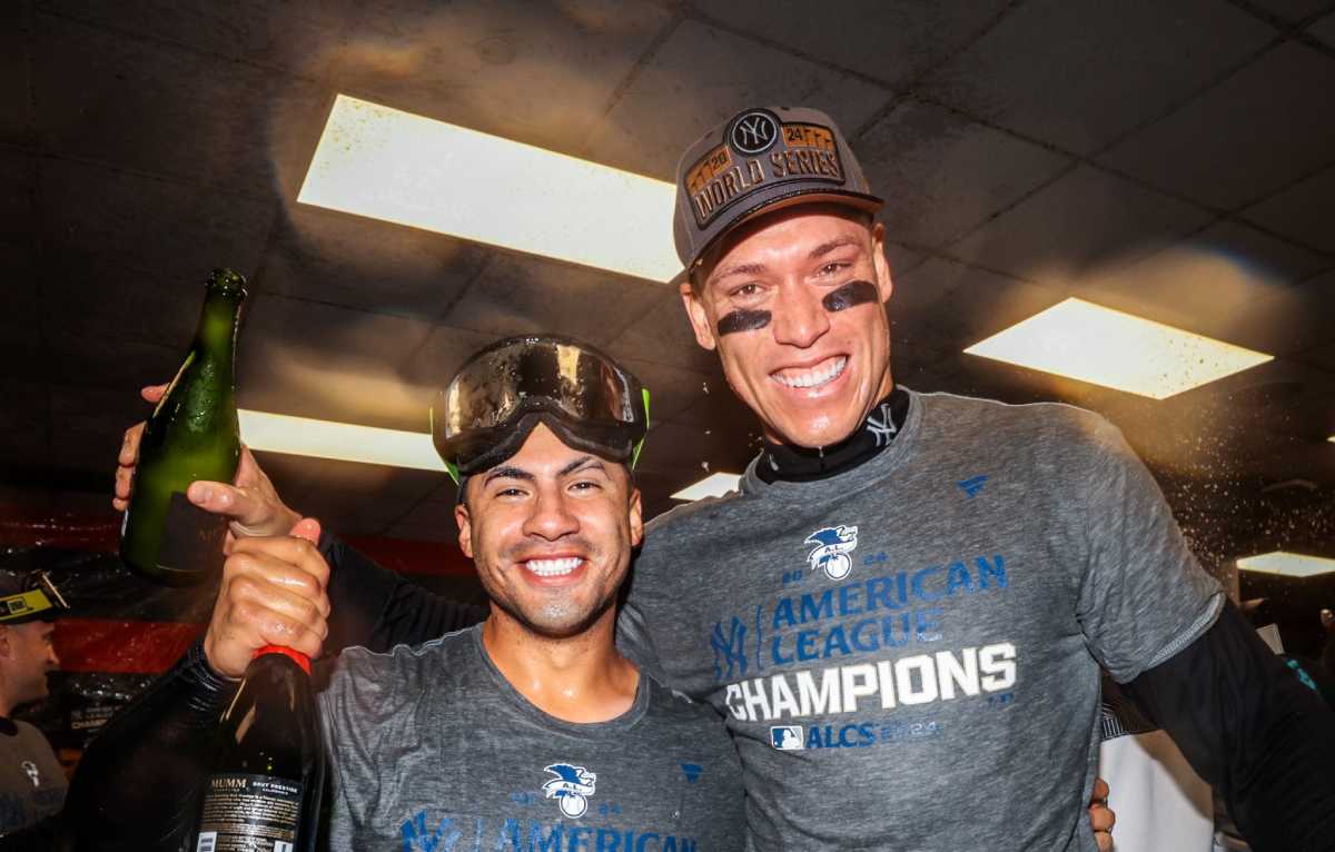 Yankees starters Aaron Judge and Gleyber Torres celebrating their AL Championship trophy after qualifying for the World Series on October 19, 2024.