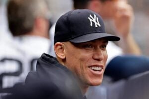 Aaron Judge wearing a Yankees cap, with only his face clearly visible, showing a focused expression.