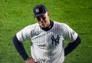 "Yankees' Aaron Judge smiling at Yankee Stadium during Game 2 of the ALCS against the Cleveland Guardians, in New York on October 15, 2024."