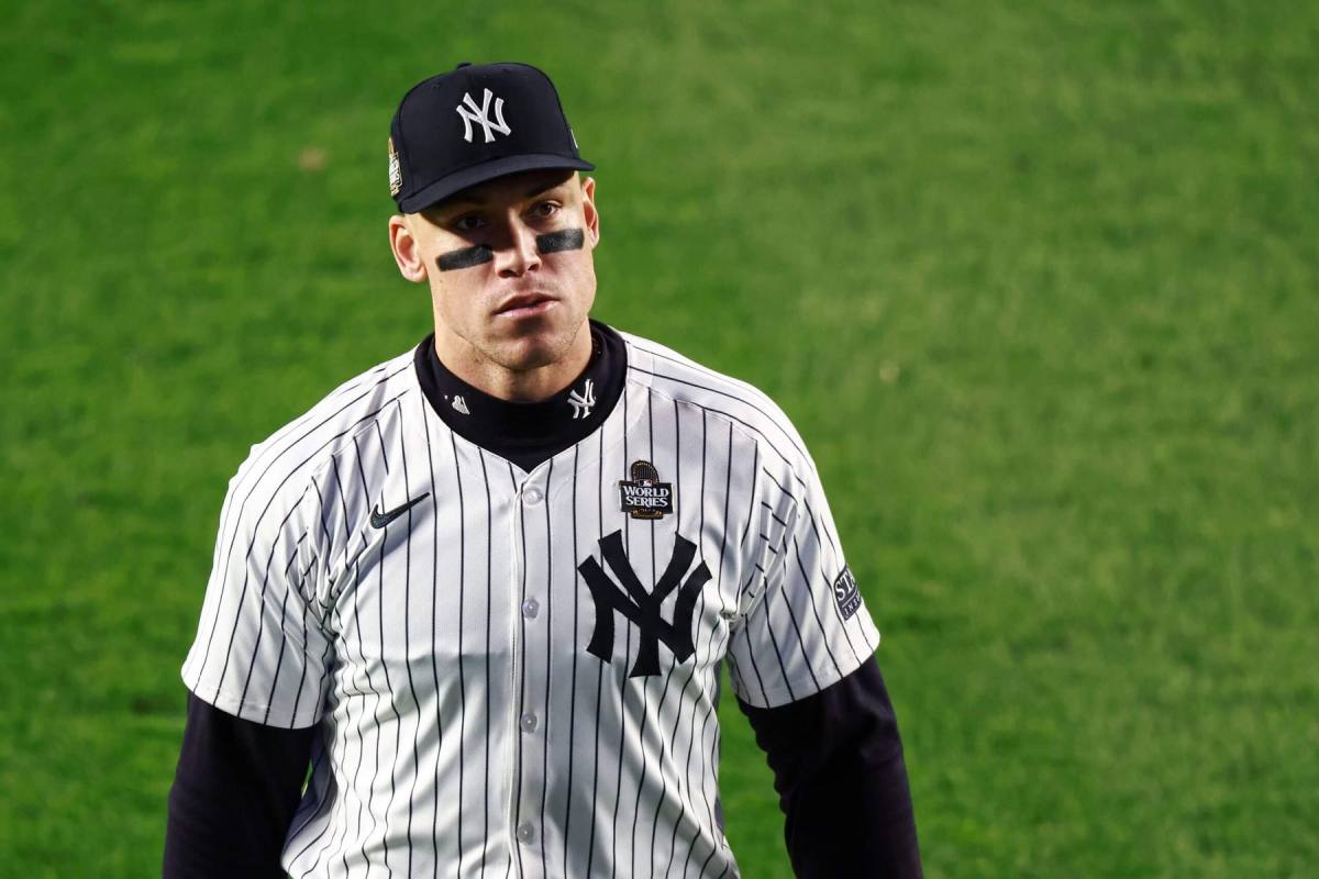 Aaron Judge walking back to the Yankees dugout after striking out in the first inning on Oct. 28, 2024, with a focused expression as he grips his bat, captured during a crucial postseason game.