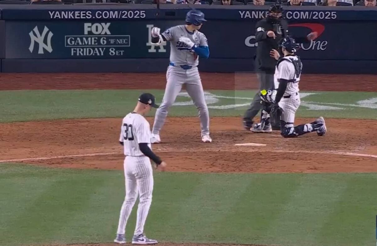 Umpire points to Yankees catcher Austin Wells charging him with catcher's interference on a foul ball by Shohei Ohtani at Yankee Stadium, Oct 30, 2024.