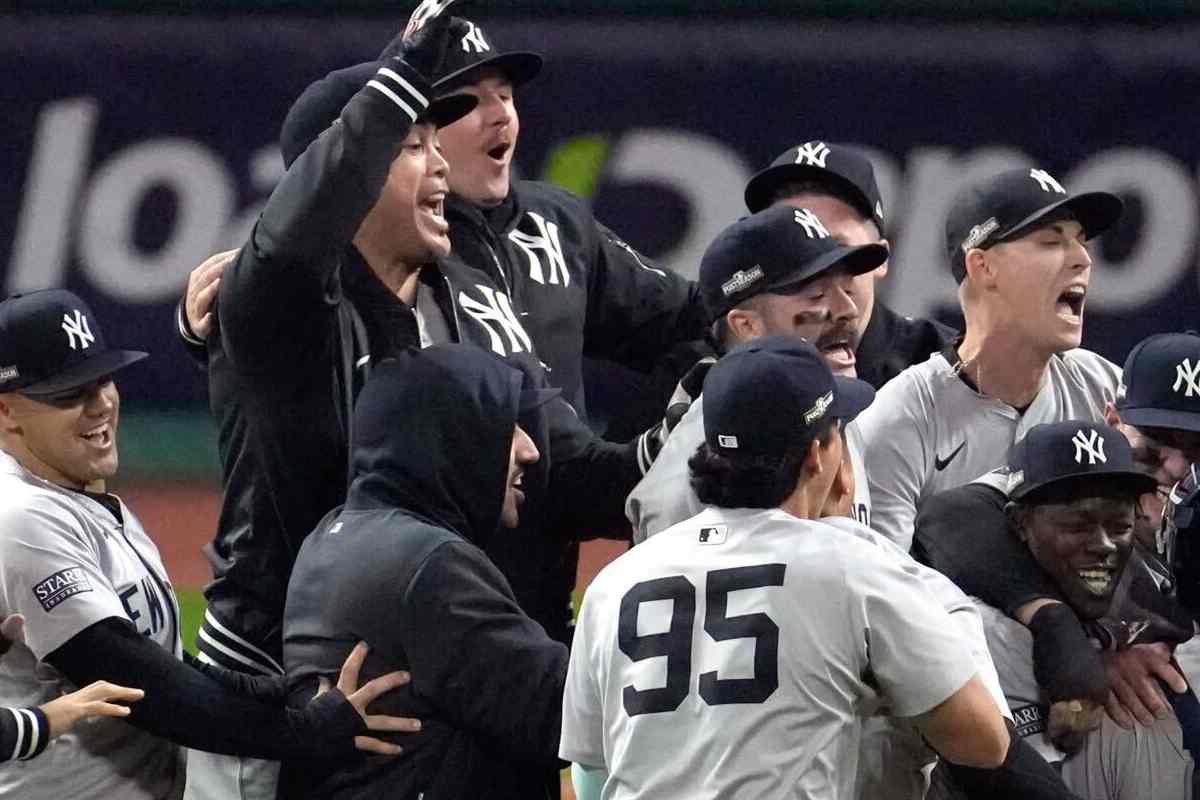 Giancarlo Stanton with New York Yankees roster celebrating their AL Championship trophy after qualifying for the World Series on October 19, 2024.