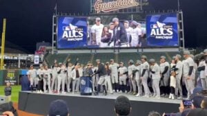 Giancarlo Stanton receiving the ALCS MVP award after the Yankees' series-clinching victory over the Cleveland Guardians on October 20, 2024, celebrating with teammates on the field at Yankee Stadium.