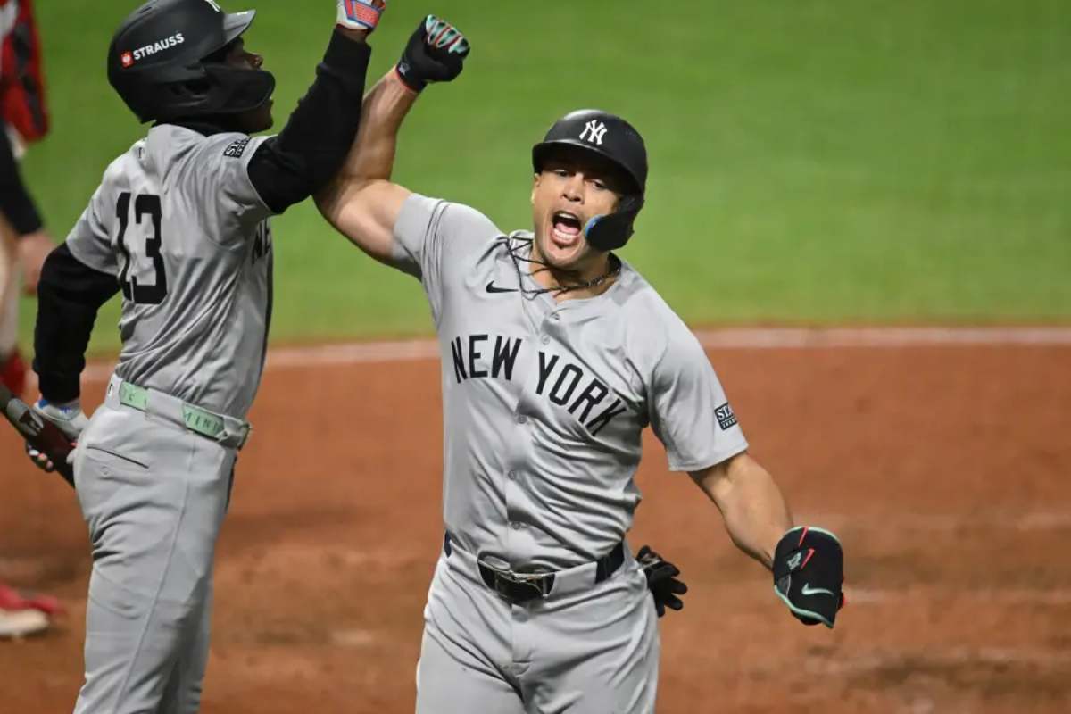 Giancarlo Stanton #27 of the New York Yankees celebrates a home run with Jazz Chisholm Jr. #13 during the eighth inning against the Cleveland Guardians during Game 3 of the American League Championship Series at Progressive Field on October 17, 2024 in Cleveland, Ohio.