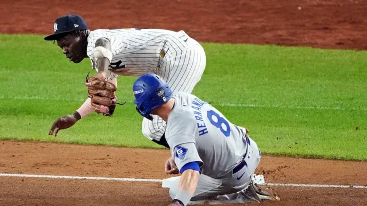 Juego 5, 30 de octubre de 2024: Enrique Hernández, de los Dodgers, avanza a tercera base tras un error de campo del tercera base de los Yankees Jazz Chisholm Jr. en la quinta entrada de las Series Mundiales en el Yankee Stadium.