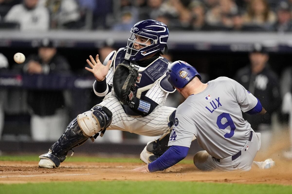 Los Angeles Dodgers’ Gavin Lux scores past New York Yankees catcher Jose Trevino during the sixth inning in Game 3 of the baseball World Series, Monday, Oct. 28, 2024, in New York.