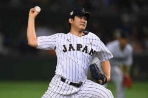 TOKYO, JAPAN - NOVEMBER 21: Tomoyuki Sugano #11 of Japan pitches in the top half of fifth inning during the WBSC Premier 12 third place play off match between Japan and Mexico at the Tokyo Dome on November 21, 2015 in Tokyo, Japan