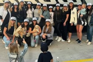 The New York Yankees players' wives, girlfriends, and dogs pose for photos as they are about to head to Los Angeles on Oct 23, 2024.