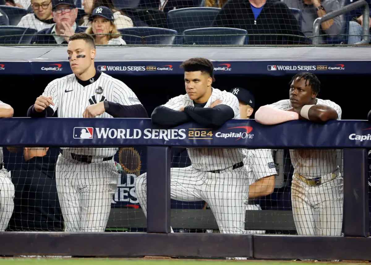 Giancarlo Stanton of the Yankees along with Aaron Judge, Anthony Volpe and DJ LeMahieu react on the dugout fence during the ninth inning.