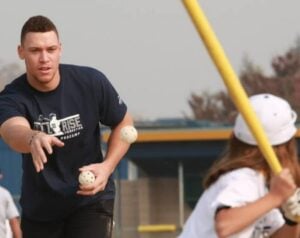 Yankees captain Aaron Judge pitches to a kid at a baseball even organized by his All Rise Foundation in 2024.