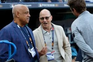 In October, 2024, Yankees general manager Brian Cashman (C) talks to Omar Minaya, special assistant to the general manager of the New York Yankees.