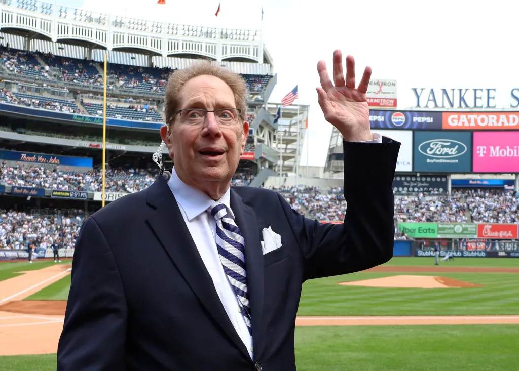 John Sterling waves to the crowd while he is honored by the Yankees in a pre-game ceremony in April, , 2024,