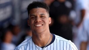 Feb 25, 2024; Tampa, Florida, USA; New York Yankees left fielder Juan Soto (22) smiles in the dugout against the Toronto Blue Jays at George M. Steinbrenner Field.