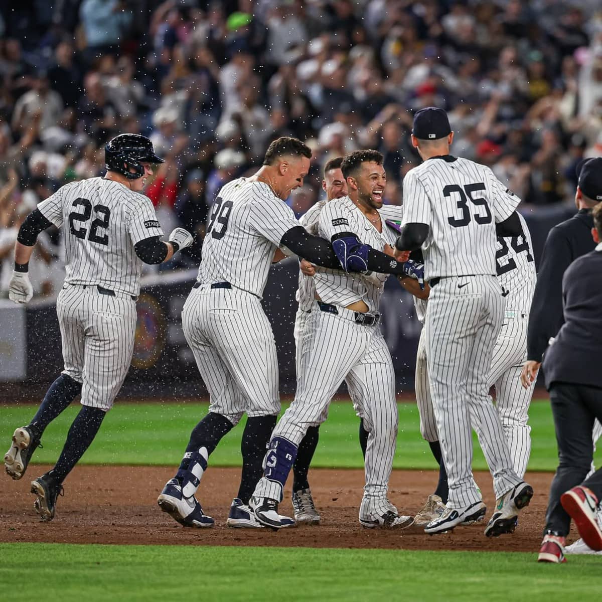 The New York Yankees team runs out of the dugout to celebrate after the save in the Yankees' 4-3 win over the Padres in Yankee Stadium, May 7, 2025.
