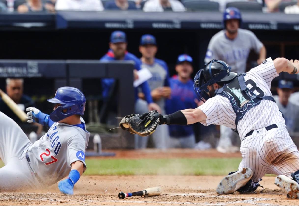 Cubs' Seiya Suzuki steals a base as Yankees' Austin Wells tries to tag him in Chicago's 4-1 win in New York on July 13, 2025.