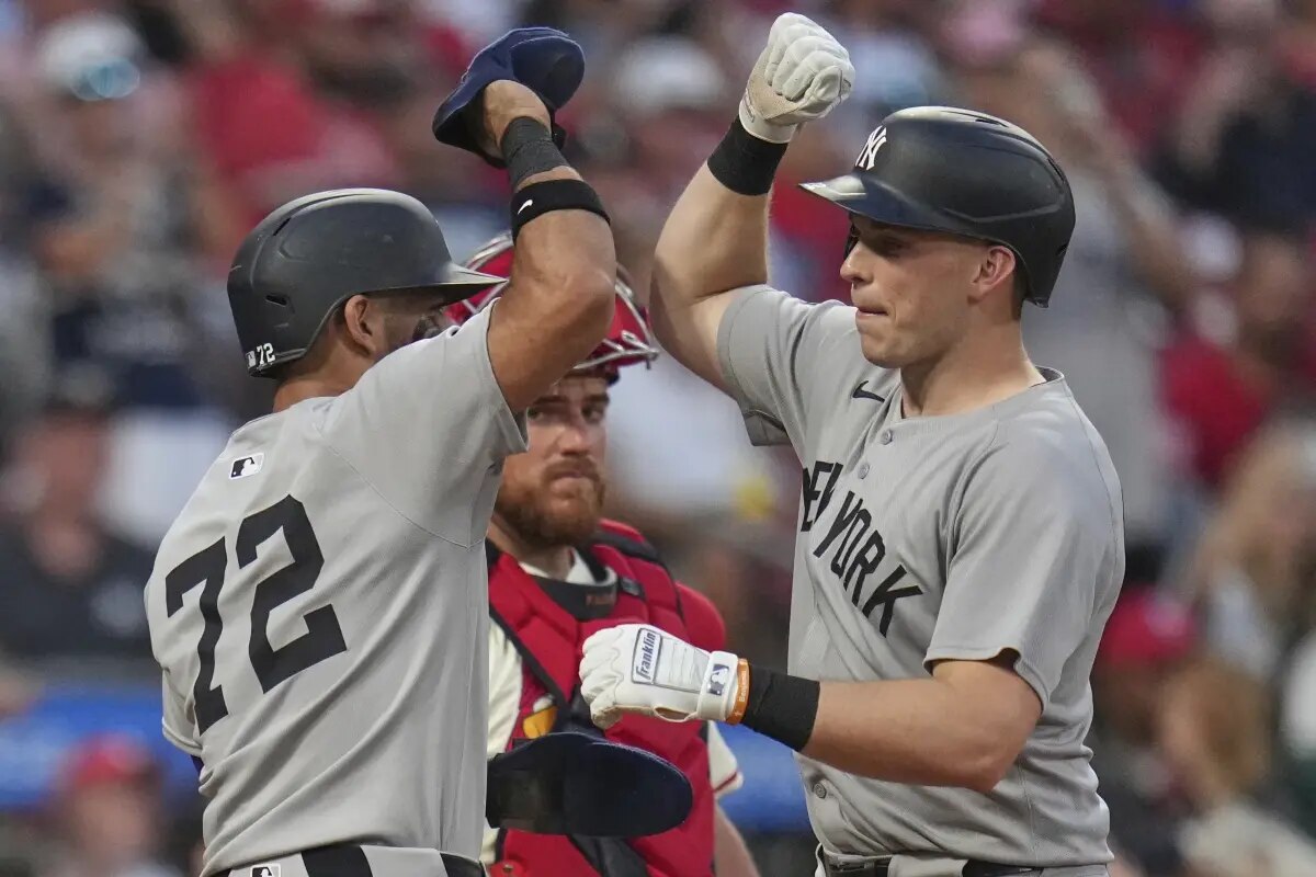 New York Yankees’ Ben Rice, right, is congratulated by teammate Jose Caballero (72) after hitting a three-run home run as St. Louis Cardinals catcher Pedro Pages, center, watches during the fourth inning of a baseball game Saturday, Aug. 16, 2025, in St. Louis.