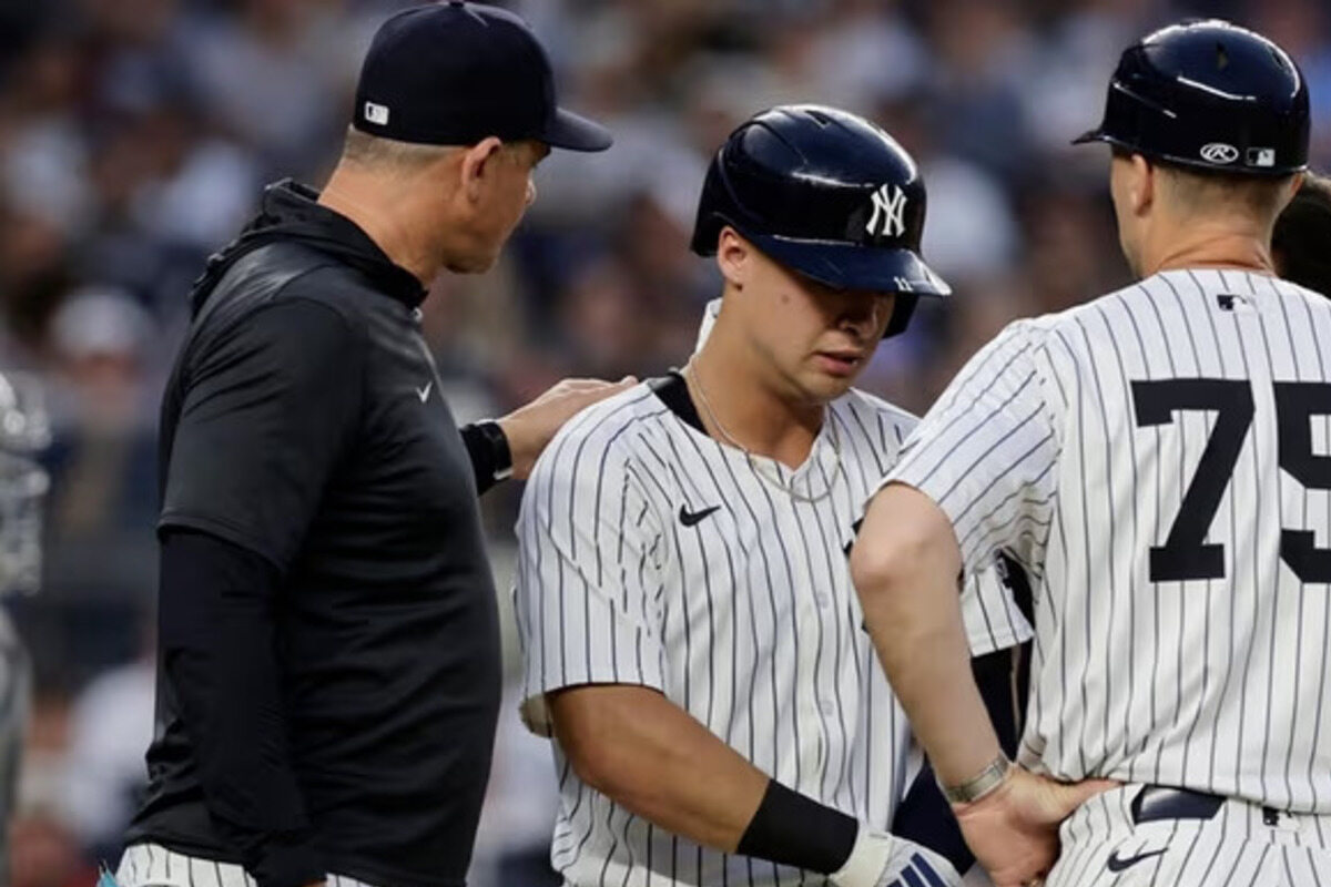Anthony Volpe #11 of the New York Yankees is checked out after being hit by a pitch during the second inning with the bases loaded against the Boston Red Sox at Yankee Stadium on Friday.
