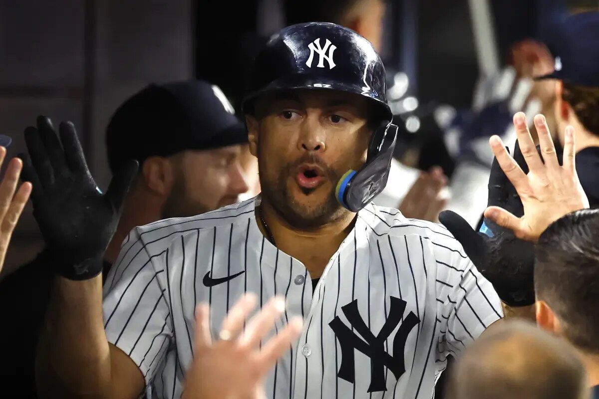 New York Yankees’ Giancarlo Stanton celebrates with teammates after hitting a two run home run during the sixth inning of a baseball game against the Washington Nationals, Tuesday, Aug. 26, 2025, in New York.
