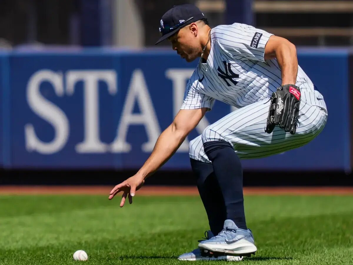 Giancarlo Stanton picks up a ball during the Yankees’ Aug. 9 game against the Astros.