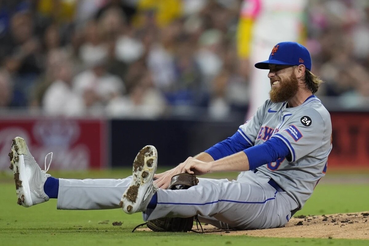 New York Mets starting pitcher Paul Blackburn stays down after getting hit by a line out by San Diego Padres’ David Peralta during the third inning of a baseball game Friday, Aug. 23, 2024, in San Diego.