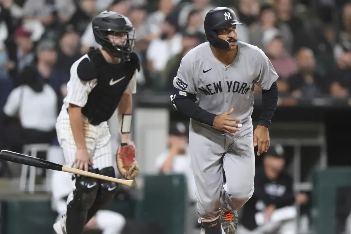 New York Yankees’ Trent Grisham, right, watches his two-run home run during the eighth inning of a baseball game against the Chicago White Sox in Chicago, Thursday, Aug. 28, 2025.