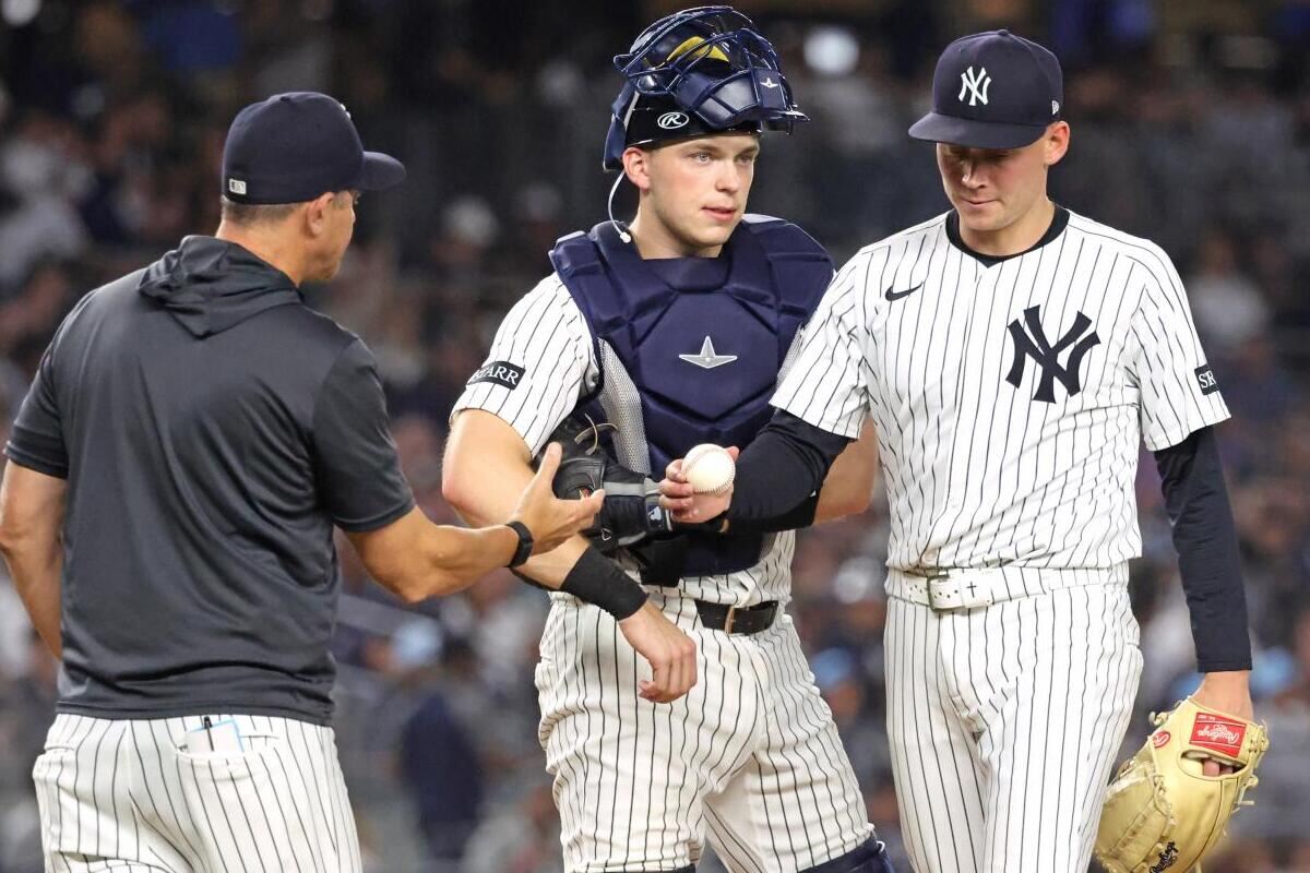 Will Warren #98 of the New York Yankees is pulled from the game by Aaron Boone #17 of the New York Yankees during the 7th inning.