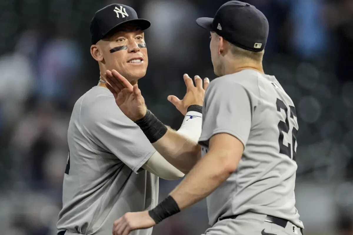 New York Yankees outfielder Aaron Judge (99) celebrates a win with Ben Rice (22) after a baseball game against the Minnesota Twins, Wednesday, Sept. 17, 2025, in Minneapolis.