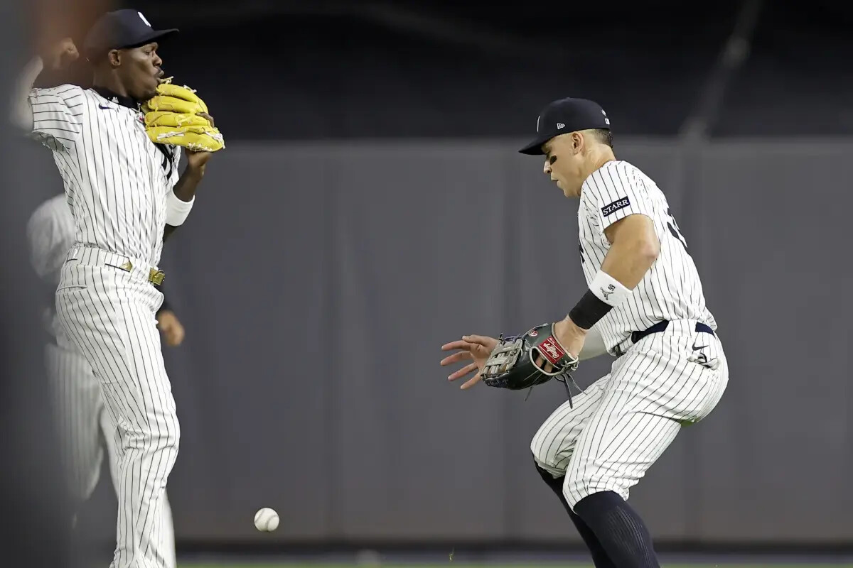 New York Yankees outfielder Aaron Judge, right and Jazz Chisholm Jr. watch a single hit by Toronto Blue Jays’ Bo Bichette fall between them during the fifth inning of a baseball game Friday, Sept. 5, 2025, in New York.
