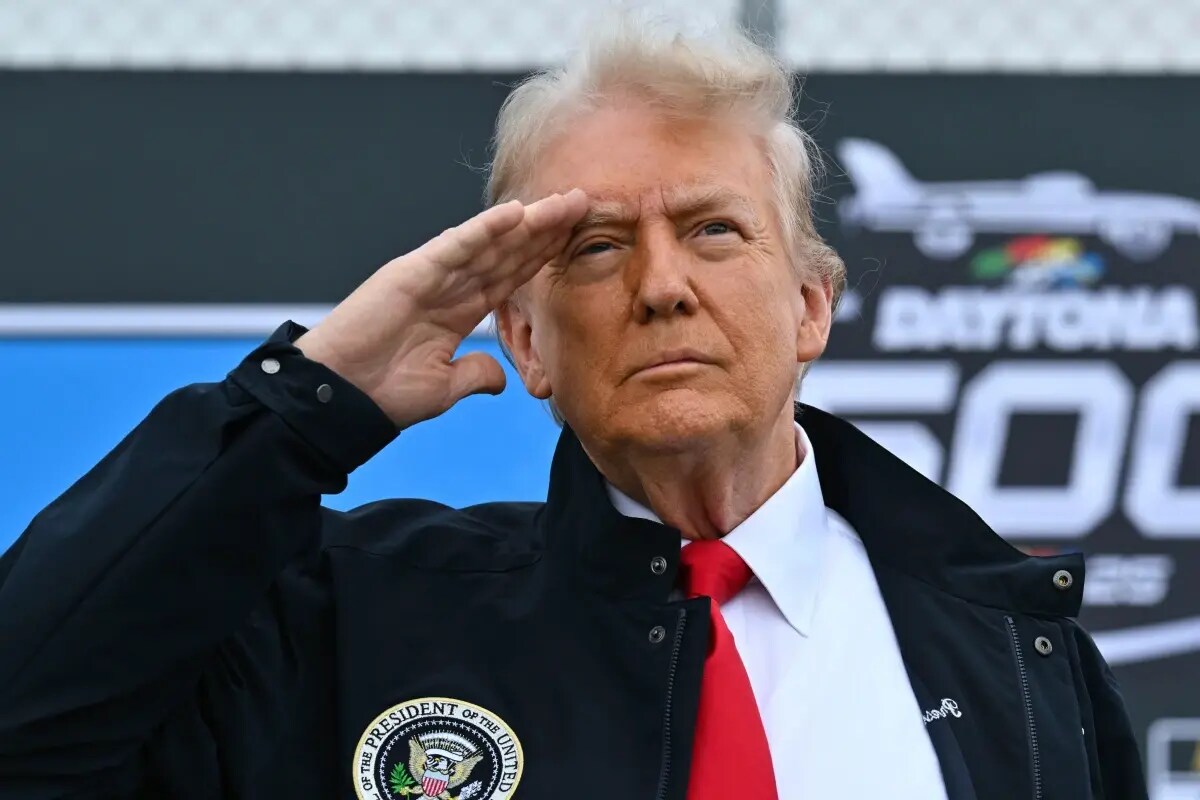 President Donald Trump salutes as he attends the NASCAR Daytona 500 auto race at Daytona International Speedway, Feb. 16, 2025, in Daytona Beach, Fla.