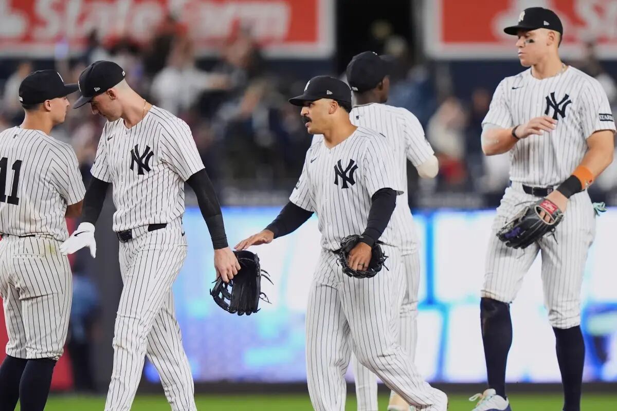 New York Yankees’ Anthony Volpe, left, and Aaron Judge celebrates with teammates after a baseball game against the Chicago White Sox Thursday, Sept. 25, 2025, in New York.