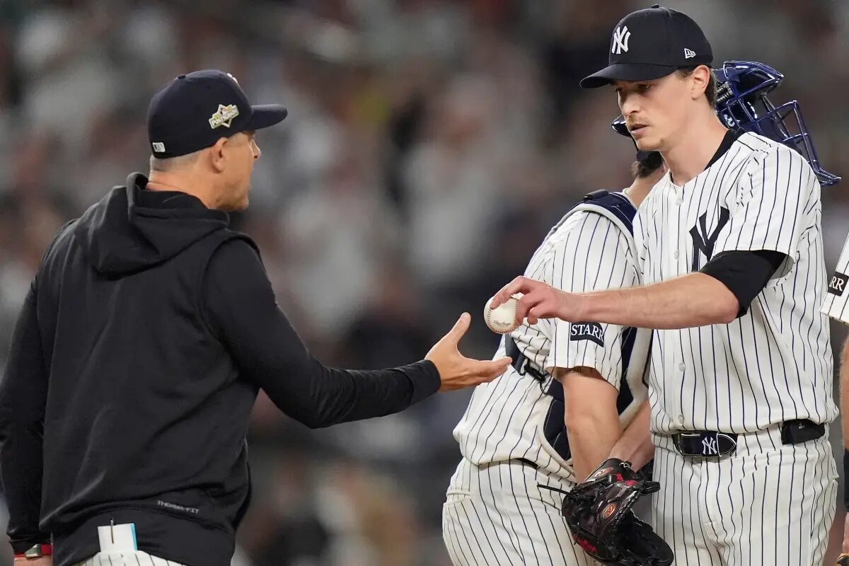 New York Yankees pitcher Max Fried, right, is relieved by manager Aaron Boone during the seventh inning of Game 1 of an American League wild-card baseball playoff series against the Boston Red Sox, Tuesday, Sept. 30, 2025, in New York.