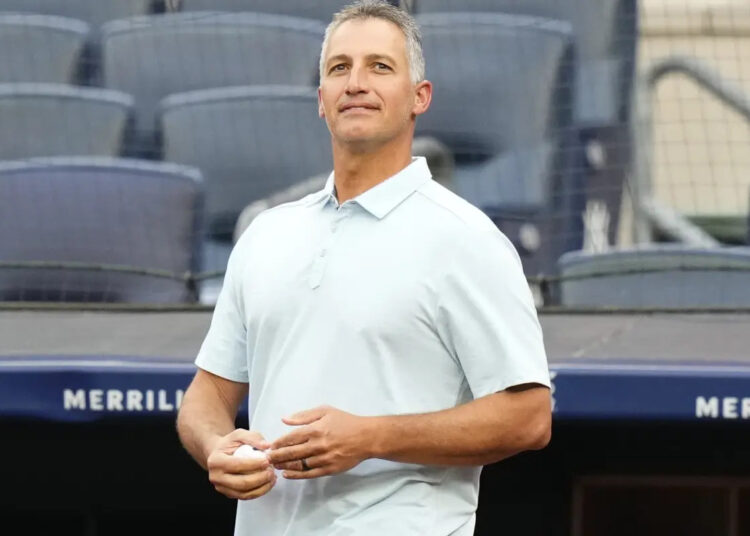 Former New York Yankees pitcher Andy Pettitte walks on the field to throw out a ceremonial first pitch before a baseball game between the Yankees and the New York Mets, Tuesday, July 25, 2023, in New York.