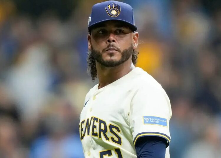 Milwaukee Brewers pitcher Freddy Peralta walks to the dugout after the top of the fifth inning in Game 2 of baseball’s National League Championship Series against the Los Angeles Dodgers, Tuesday, Oct. 14, 2025, in Milwaukee.