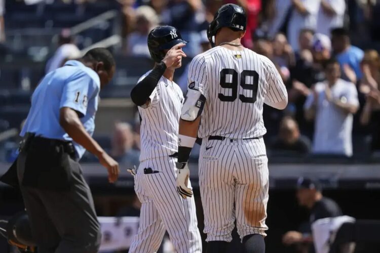 New York Yankees’ Aaron Judge (99) celebrates with Cody Bellinger (35) after hitting a two run home run during the ninth inning of a baseball game against the Chicago Cubs, Saturday, July 12, 2025, in New York.